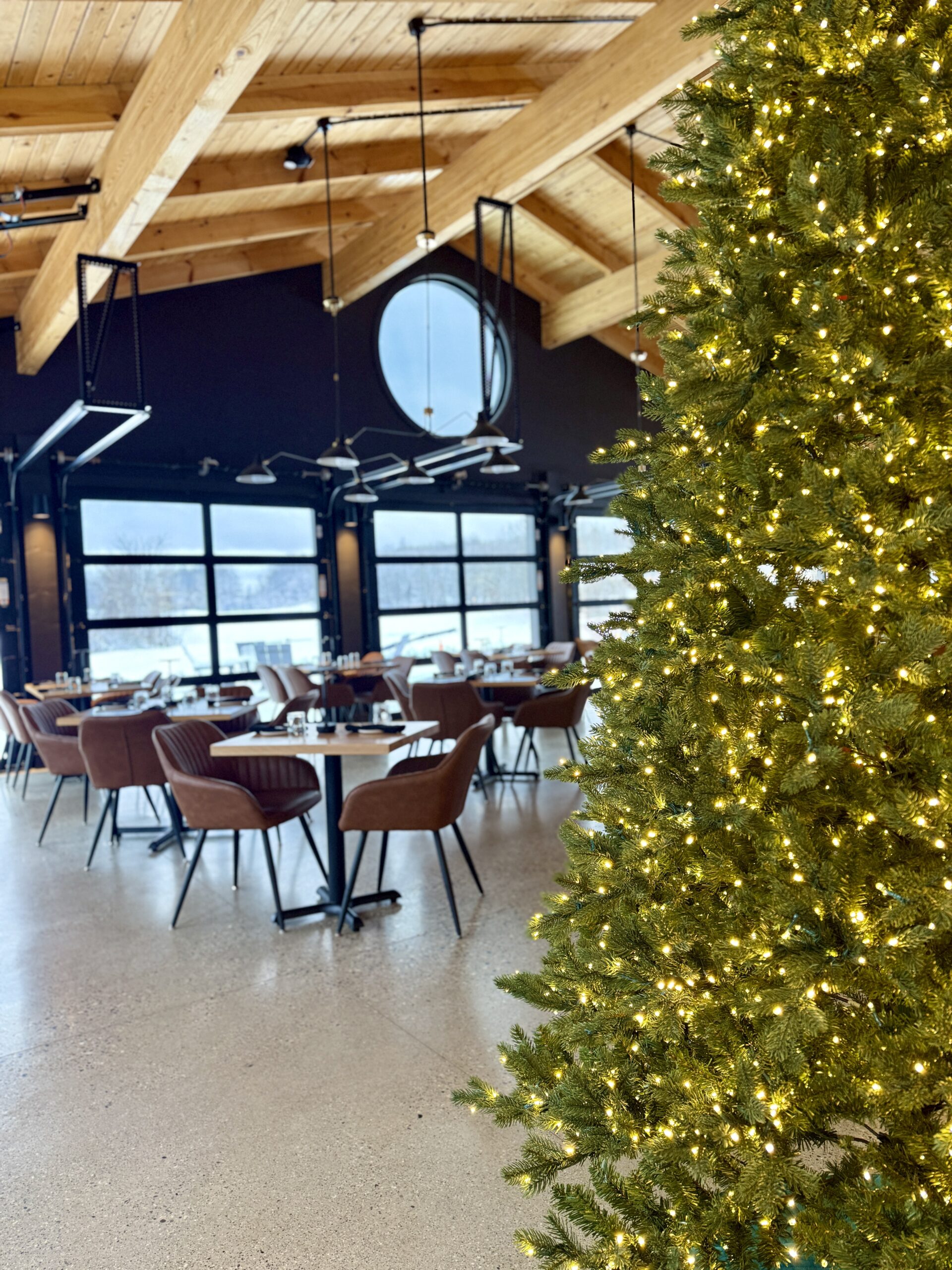 Restaurant cascading wooden ceilings and views of a golf course with holiday decor